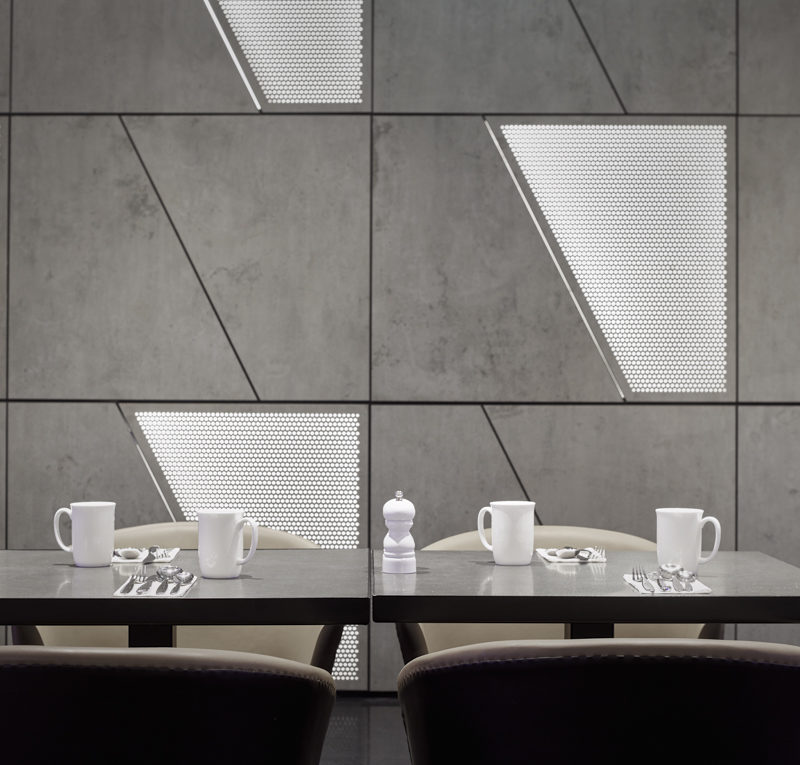 A set table in Blake's Breakfast dining area with white mugs and a grey background
