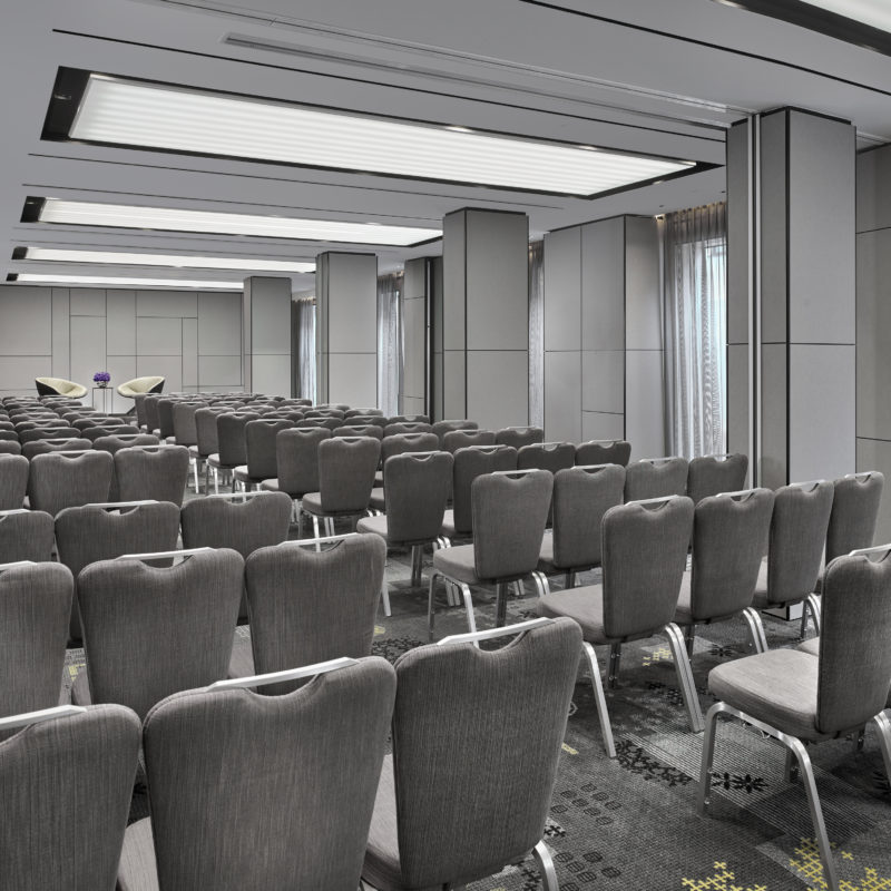 A room full of grey chairs in a grey room