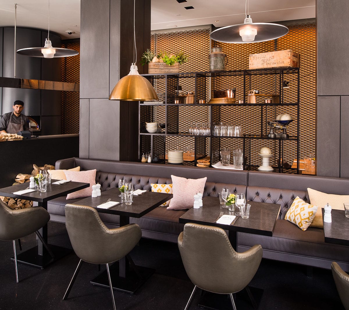 Tables in Florentine Restaurant with a bookshelf in front of a warm orange glow