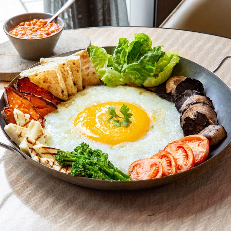 The Ostrich Egg Vegetarian Full English Breakfast comes with fried haloumi, portobello mushrooms, tomatoes, baked beans and sourdough bread.