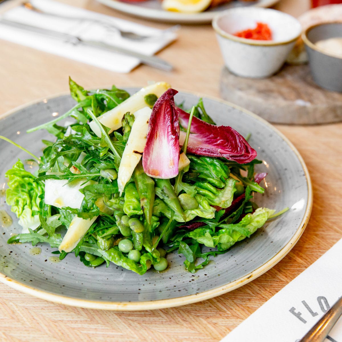 A green asparagus salad, served with peas, green beans and broad beans.